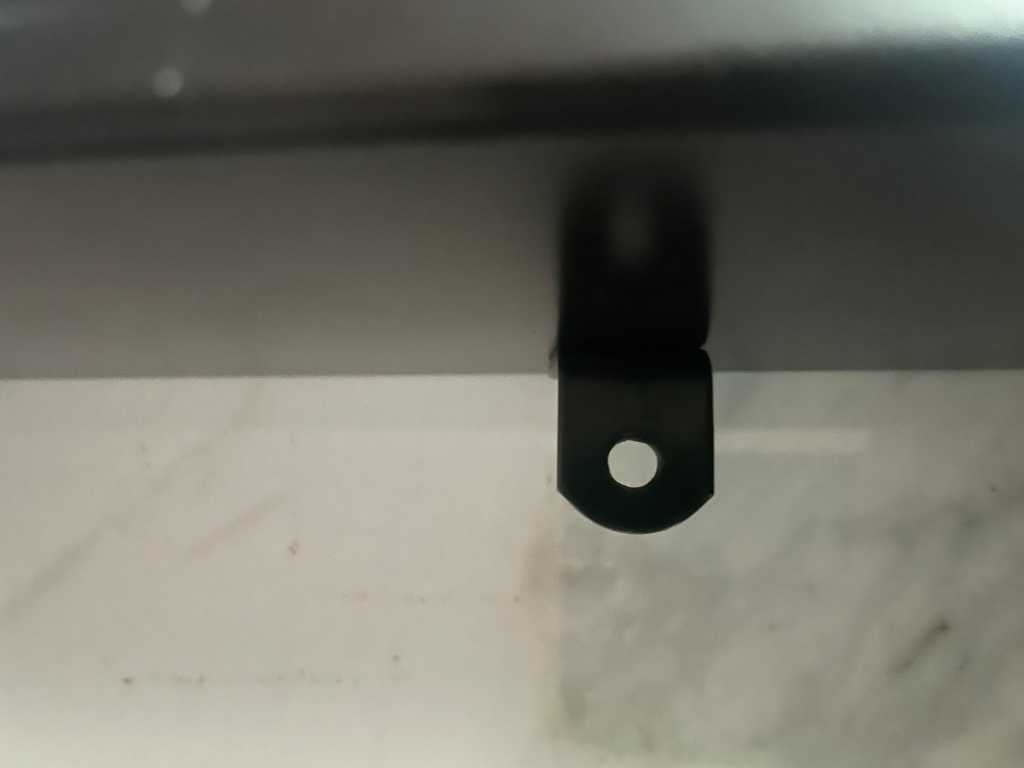 10 Second challenge - Black metal bracket on a white surface