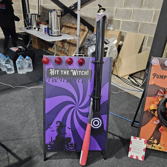 Halloween-themed game setup with a purple board labelled 'Hit the Witch!' and a red bat.