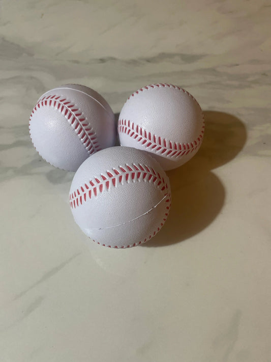 Three white baseballs with red stitching on a marble surface