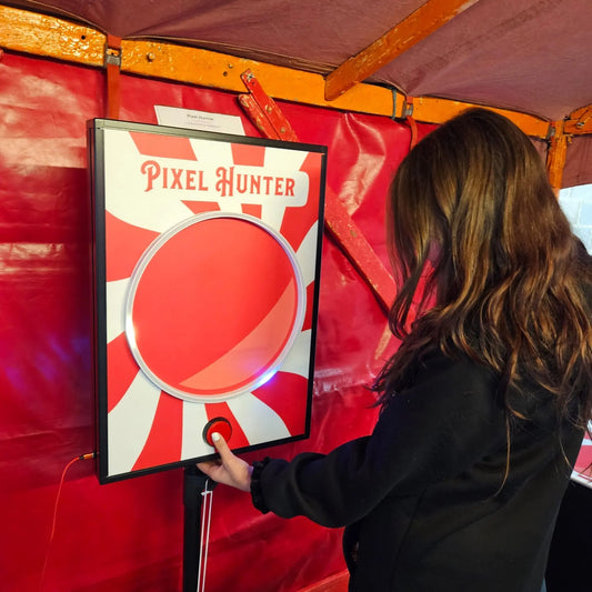 Girl Playing Pixel Hunter offered by Big Top Carnival Co.