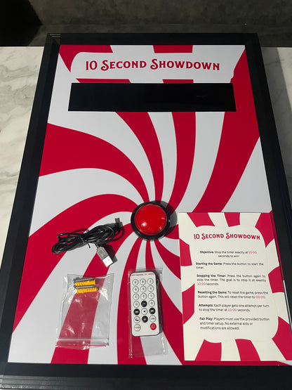 10 Second challenge - Product packaging with red and white design, featuring a remote control and cables on a white background.