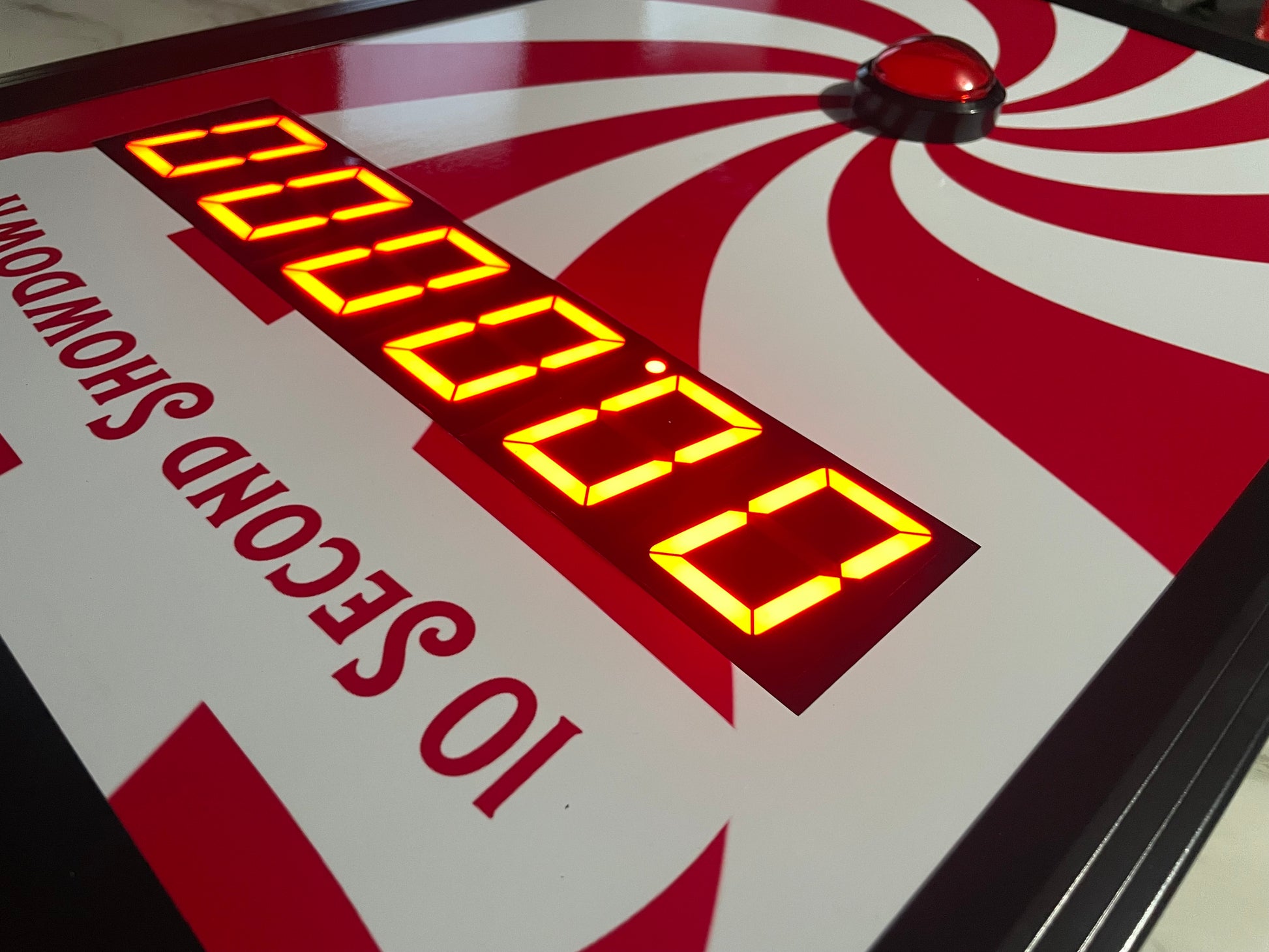 10 Second challenge - Close-up of a digital timer on game board with red and white design