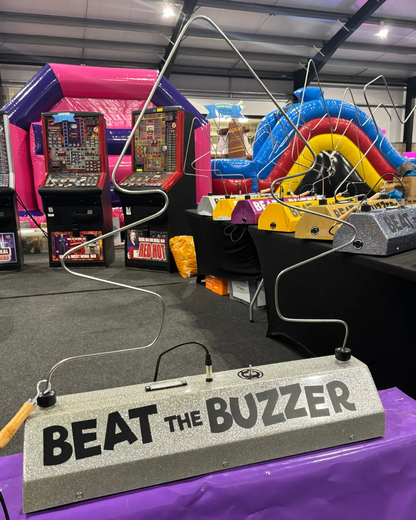 Game console with 'Beat the Buzzer' sign in an arcade setting