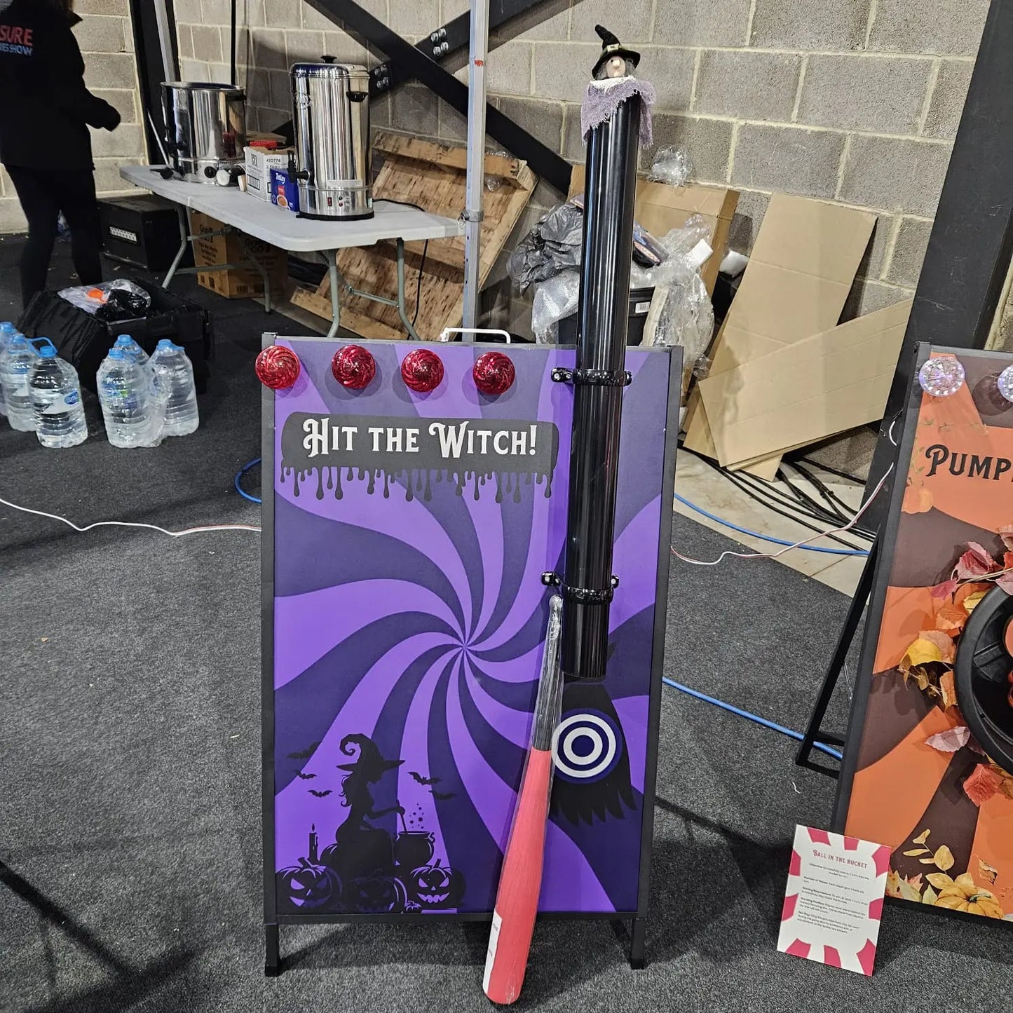 Halloween-themed game setup with a purple board labelled 'Hit the Witch!' and a red bat.