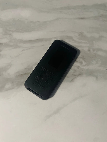 Black controller on a marble surface