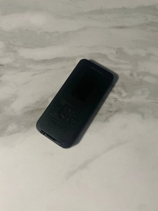 Black controller on a marble surface